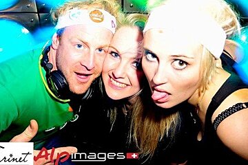 three people in a nightclub,one girl sticking her tongue out