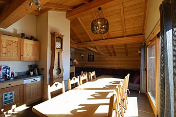 an image of a long dining table and chairs in a chalet