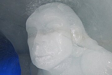 Face of a man carved in ice at the Grotte de Glace