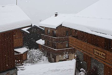 A picture of chalet rooftops covered in snow