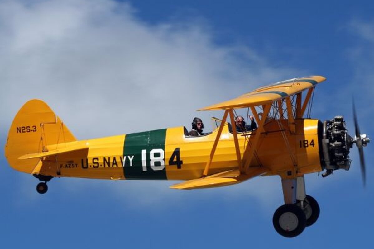 A yellow and green plane with the number 184 on the side