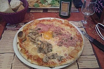 An image of a pizza with unusual toppings at a restaurant brasserie in a ski resort in the French Alps