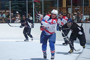 A hockey player wearing a red white and blue jersey with the word flying on it