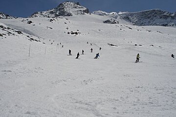 A group of people skiing down a snow covered slope