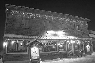 A black and white photo of a building that says restaurant le bisse