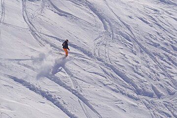 A person is skiing down a snow covered slope