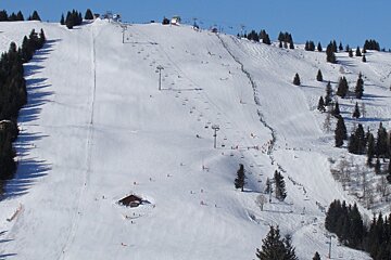 A ski slope with many skiers on it