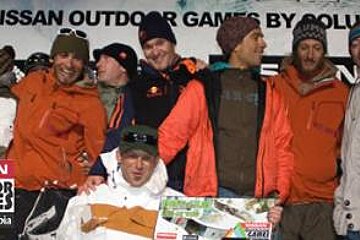 A group of people standing in front of a sign that says nissan outdoor games