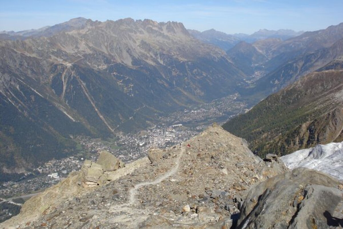 A view of a mountain range with a city in the distance