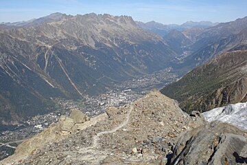 A view of a mountain range with a city in the distance