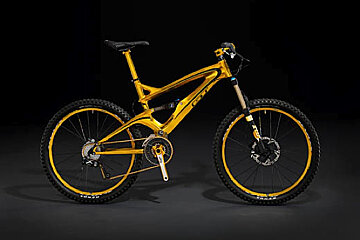A yellow bicycle with the word gt on the front