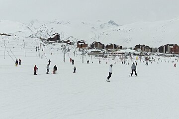 A group of people skiing down a snow covered slope