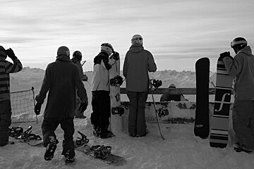 An image of some snowboarders contemplating an off piste section 