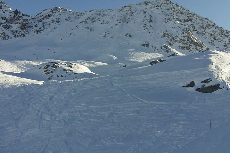 Bare Mont Gele with tracks in snow in front