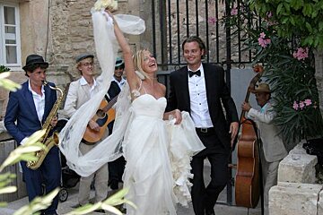 a picture of a couple who just got married walking out of a building