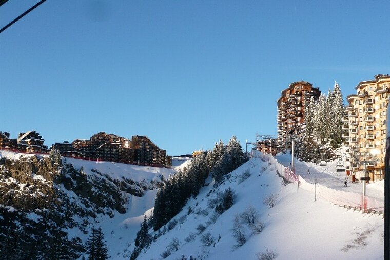 A ski resort with a lot of buildings in the background