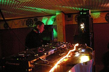 A man is playing music on a pioneer machine