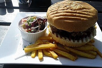 A hamburger and french fries on a white plate
