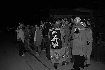 A group of people wearing jackets with a picture of a man on the back