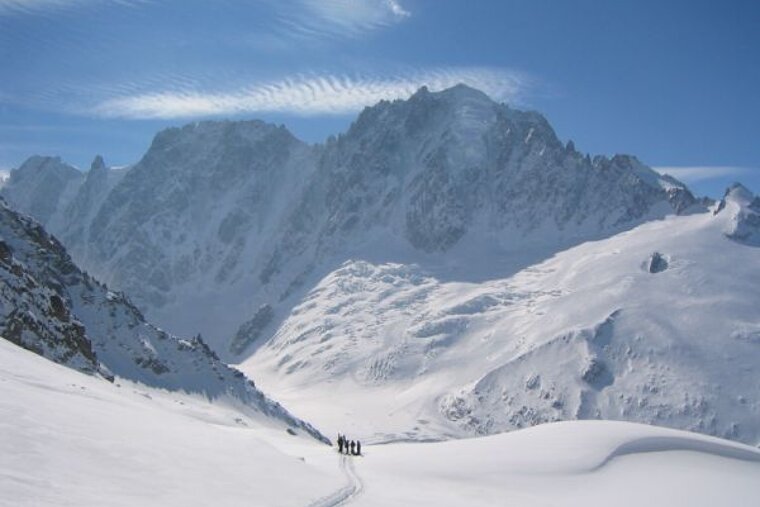 A group of people skiing down a snowy mountain