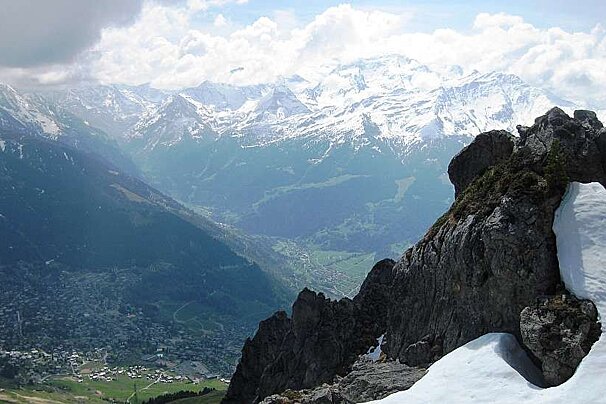An image of a view of Verbier in summer with a patch of snow in the mountains