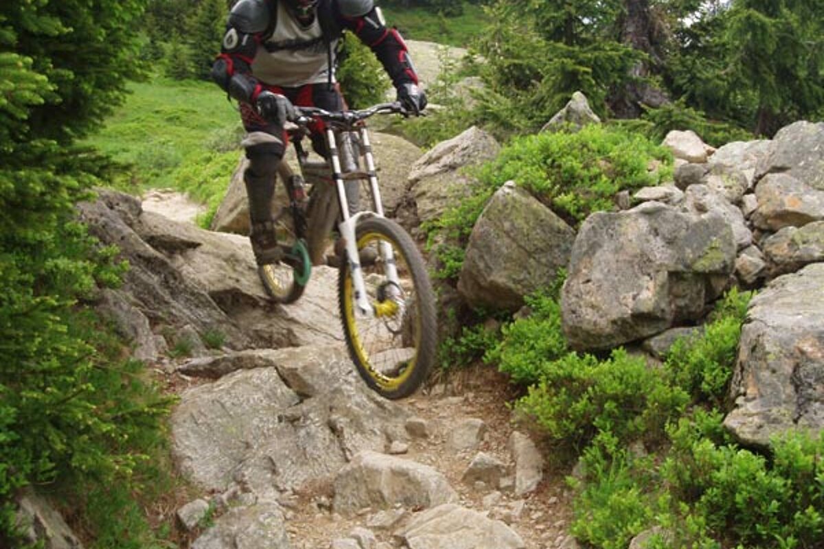 A person riding a bike on a rocky trail
