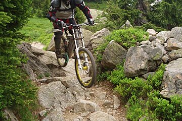 A person riding a bike on a rocky trail