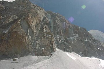 A person is walking up a snowy mountain