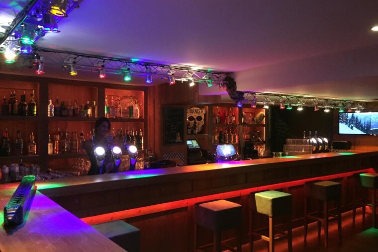 Woman behind the bar in Drop Zone bar Tignes