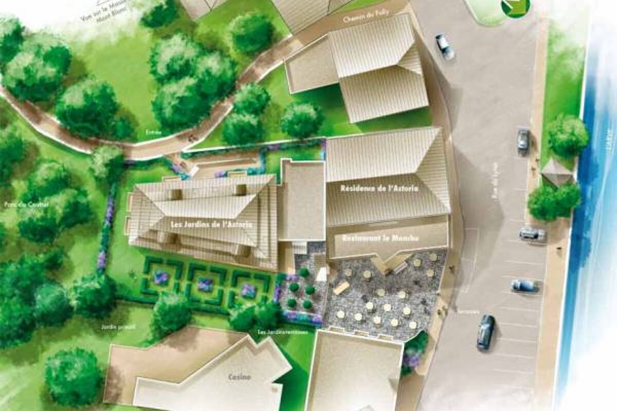 An aerial view of a building with a lot of trees around it