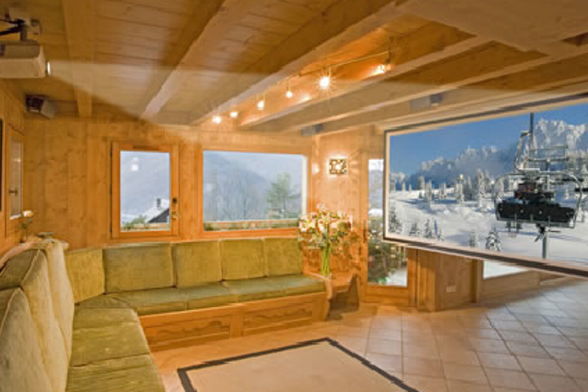 A ski lift is shown on a large screen in a living room