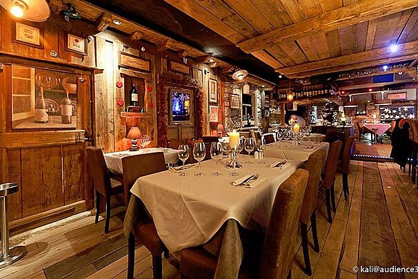 an image of a room with dining tables with table cloths on