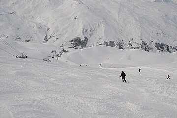Skier skiing down the 3 Marches piste