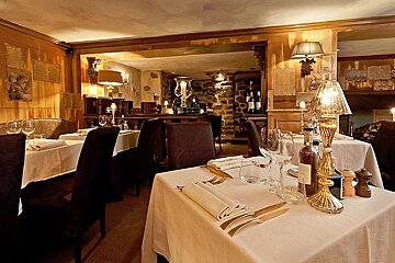 an image of a room with restaurant tables and a lamp lit up on one