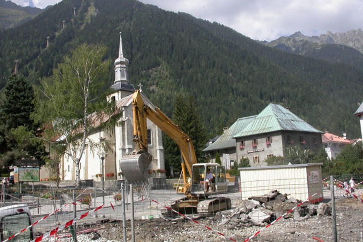 A construction site with a church in the background