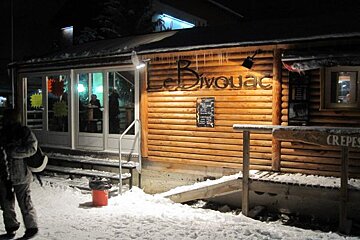 A wooden building with a sign that says crepes on it