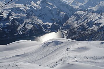 A snowy mountain range with a lake in the middle