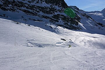 An image of a snowboarder getting some speed on a firm run