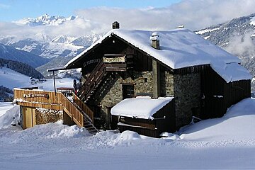 An image of a chalet restaurant in the snow in the ski resort of Montalbert in the French Alps