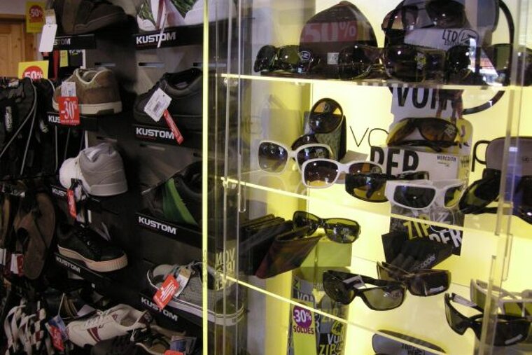 A store display of kustom shoes and sunglasses