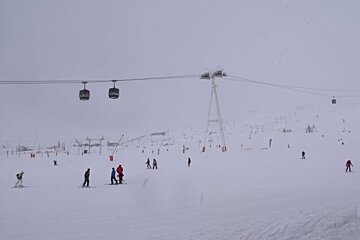 A group of people skiing down a snow covered slope