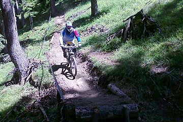 A person riding a bike on a trail in the woods