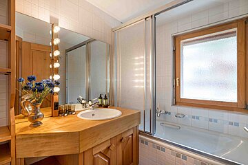 A bathroom with a sink a mirror and a window