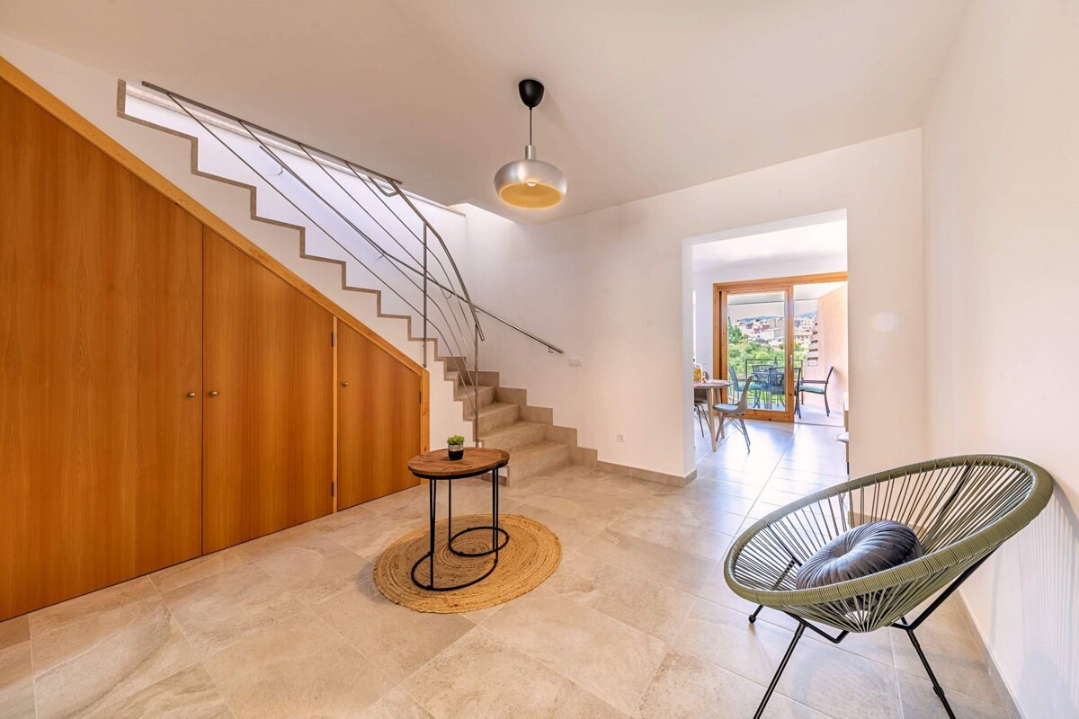 A chair sits in a hallway next to a staircase