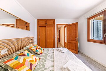 A bedroom with a king size bed and a mirror