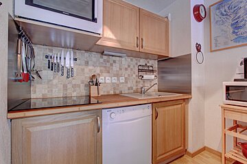 A kitchen with a bosch dishwasher and a microwave