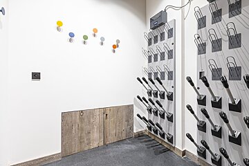 A room with a bunch of hooks on the wall