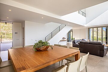 A living room with a wooden table and chairs