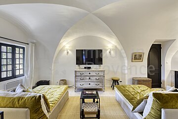 A living room with a dresser and a flat screen tv