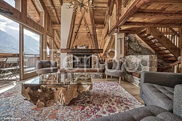 A living room with a fireplace and stairs taken by turbo holidays
